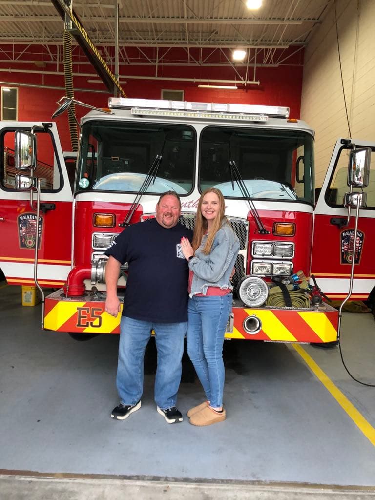 Mary Ann Biancone with the Ambu Bar founder in front of a fire engine